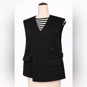 Unique assumetrical vest with pockets and button strap.  Very modern. L